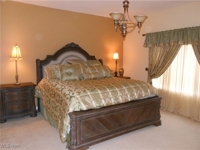 Master Bedroom with light colored carpet and a chandelier. The bed is a king size. | Image 22