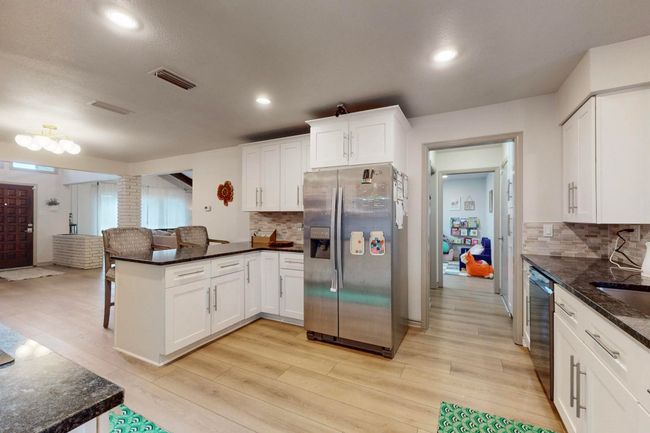 Kitchen featuring stainless steel appliances, light wood-style floors and peninsula | Image 11