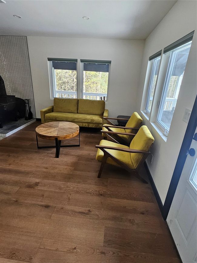 Living area with hardwood / wood-style flooring, recessed lighting, and baseboards | Image 11