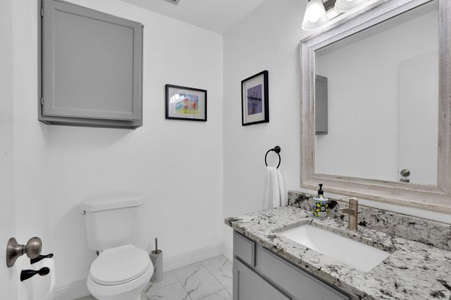 Half bath featuring marble finish flooring and vanity | Image 17