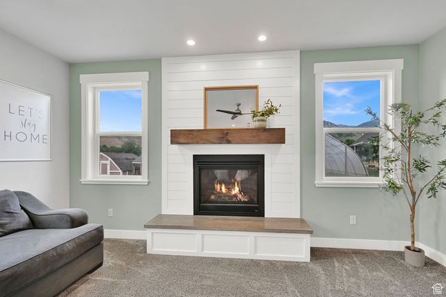 Living area featuring carpet, a large fireplace, and recessed lighting | Image 20
