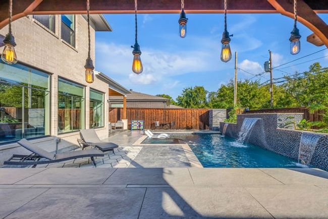 View of swimming pool with pool water feature and a patio | Image 17