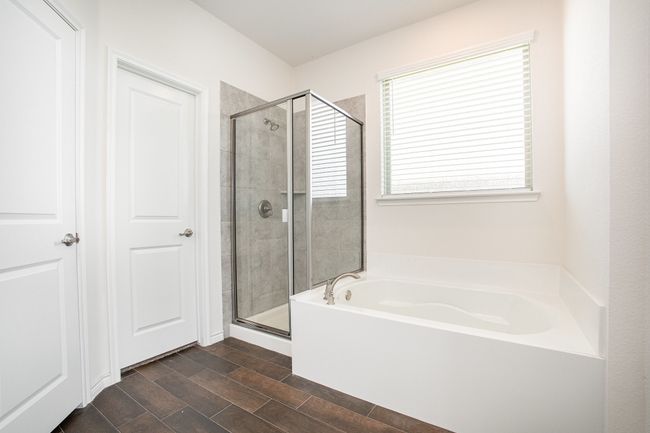 Bathroom with a bath, a stall shower, and wood finished floors | Image 19