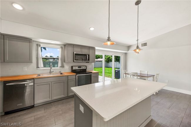 Kitchen with plenty of natural light, a kitchen island, and stainless steel appliances | Image 20