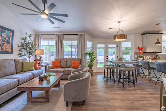 Living room featuring a textured ceiling, hardwood / wood-style flooring, plenty of natural light, and french doors | Image 26