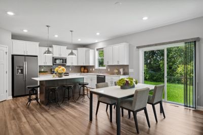 (Photo of model home, finishes will vary) Soaked in natural sunlight, the homes eat- in dining room is a wonderful spot to gather. | Image 3