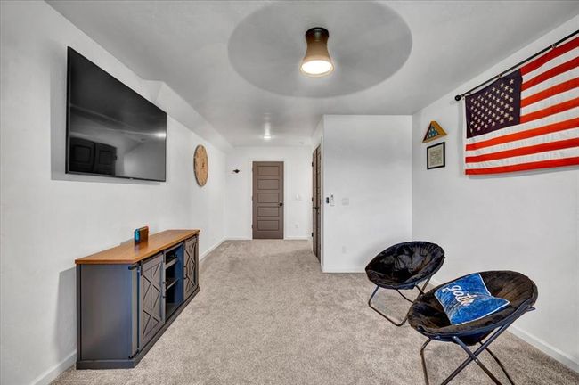 Sitting room featuring carpet flooring, baseboards, and ceiling fan | Image 49