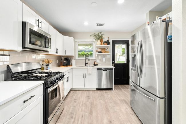 Kitchen with stain, ess appliances, Moen faucet and quartz counter tops. | Image 7