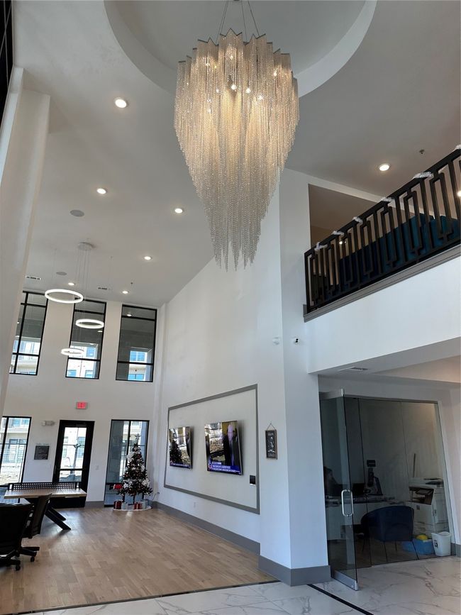 Building lobby featuring a towering ceiling and recessed lighting | Image 19
