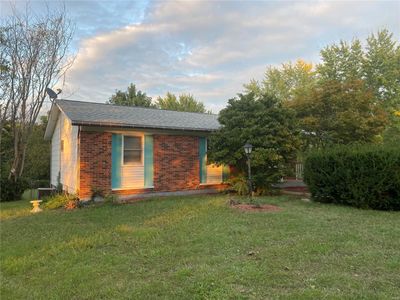 View of property exterior featuring a lawn | Image 1