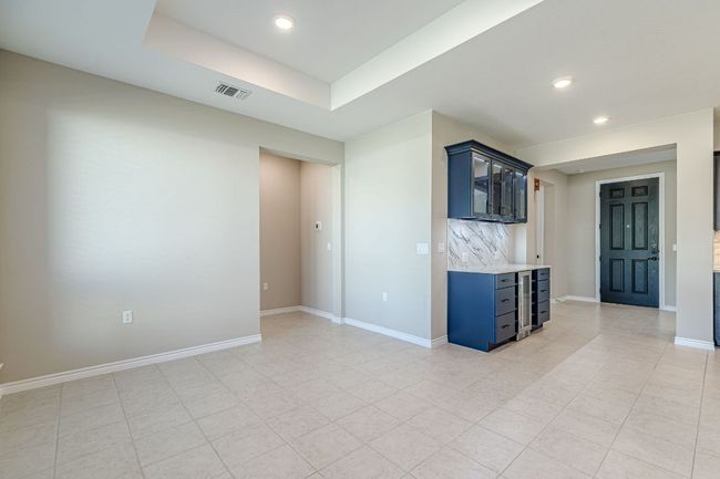 Empty room with recessed lighting, a tray ceiling, and light tile patterned flooring | Image 18
