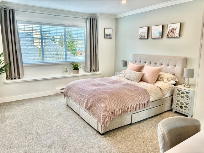 Carpeted bedroom featuring ornamental molding and a baseboard heating unit | Image 14
