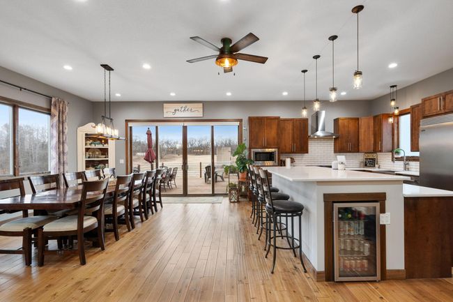 Patio Doors lead to a large deck with views of the back acreage | Image 6