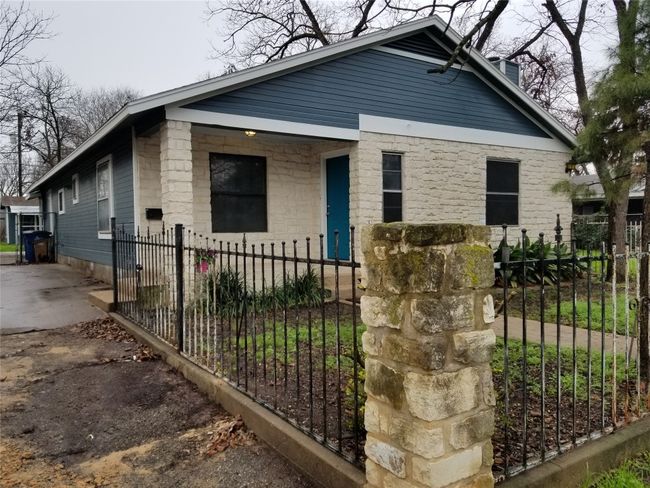View of front of home with a fenced front yard, a chimney, and covered porch | Image 21