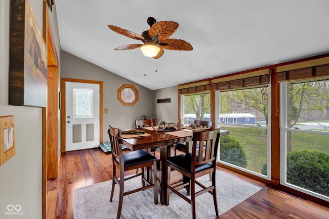 dining area featuring vaulted ceiling, ceiling fan, and Brazilian Cherry wood finished floors | Image 11