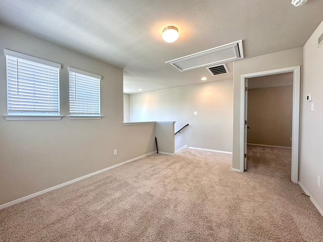 Spare room with attic access, carpet flooring, and a smoke detector | Image 22