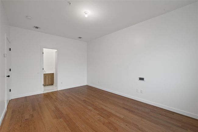 Spare room with wood finished floors and baseboards | Image 25
