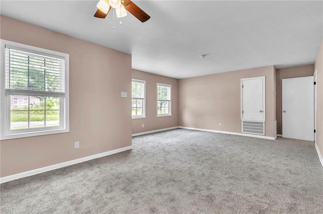 Spare room with carpet, a ceiling fan, and baseboards | Image 14