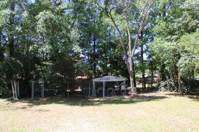 View of yard with exterior structure, fence, and an outdoor structure | Image 6