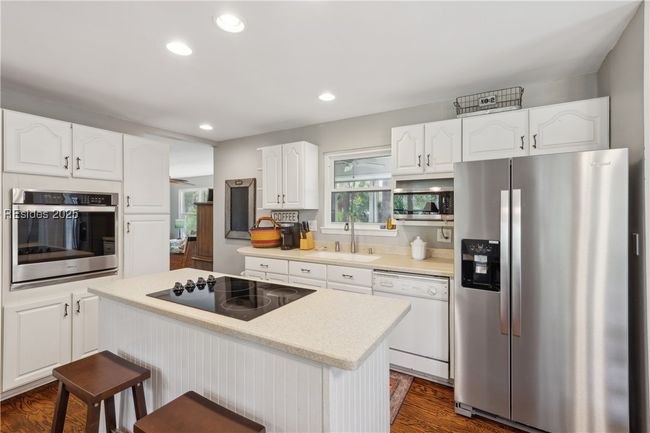 Updated chef's kitchen with stainless steel appliances & ample storage, efficient flow and a window over the sink for a view while prepping and cooking. | Image 15