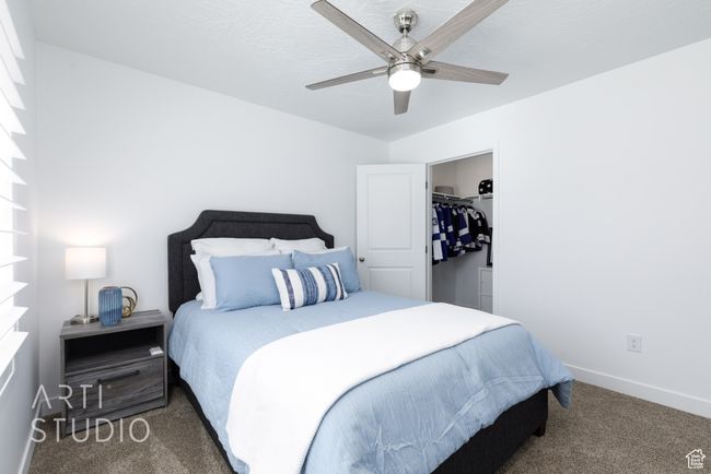 Carpeted bedroom featuring a ceiling fan and baseboards | Image 32