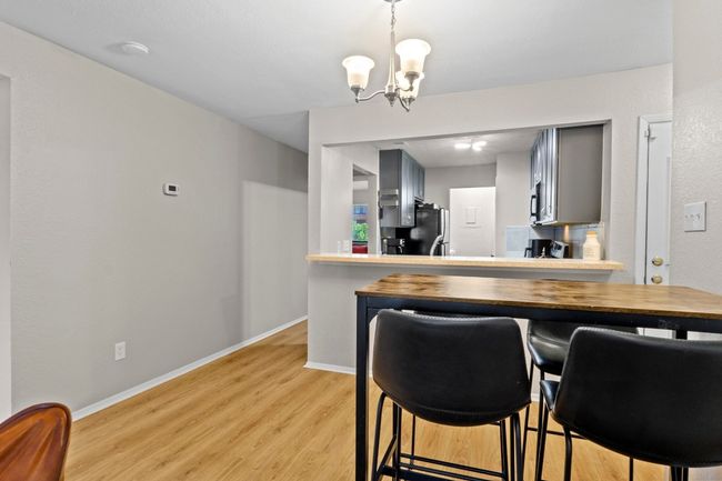 The living room flows into a dining area. | Image 6