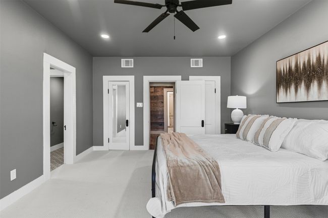 Bedroom featuring connected bathroom, light carpet, baseboards, recessed lighting, and ceiling fan | Image 25