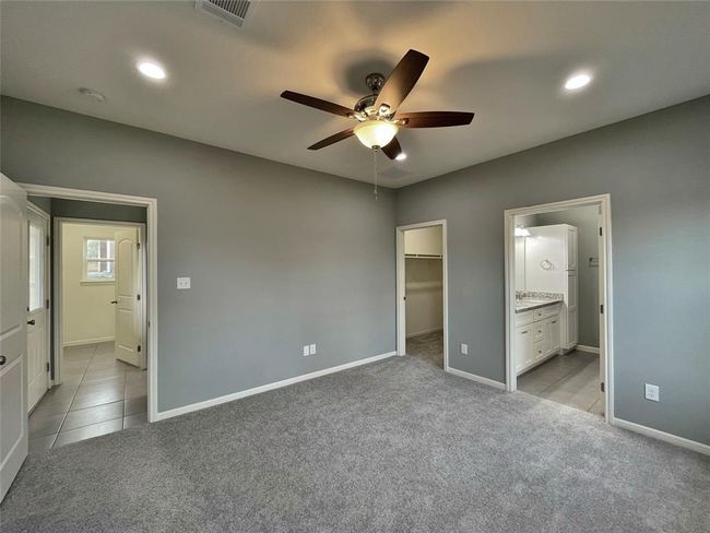 Located in the back of the home, the primary bedroom has easy access to the kitchen, laundry room and the backdoor. | Image 7