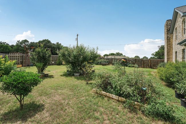 Fenced backyard with a vegetable garden | Image 32