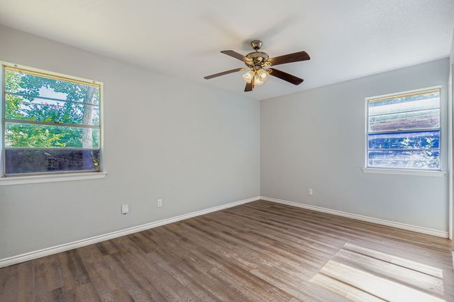 Spare room featuring wood finished floors and a ceiling fan | Image 5