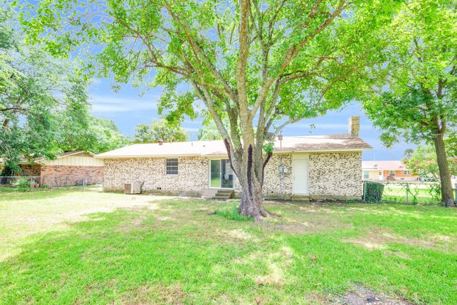 Back of property featuring a chimney, a fenced backyard, brick siding, and entry steps | Image 20