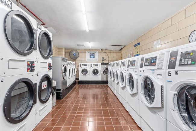 Community laundry room featuring stacked washer / drying machine and independent washer and dryer | Image 9