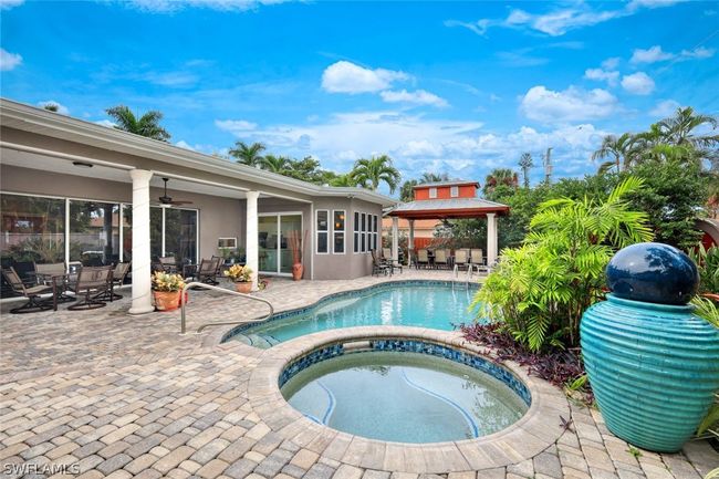 View of pool with a patio, a gazebo, and an in ground hot tub | Image 1