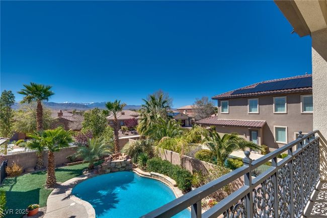 View of pool with a fenced backyard, a mountain view, and a fenced in pool | Image 57