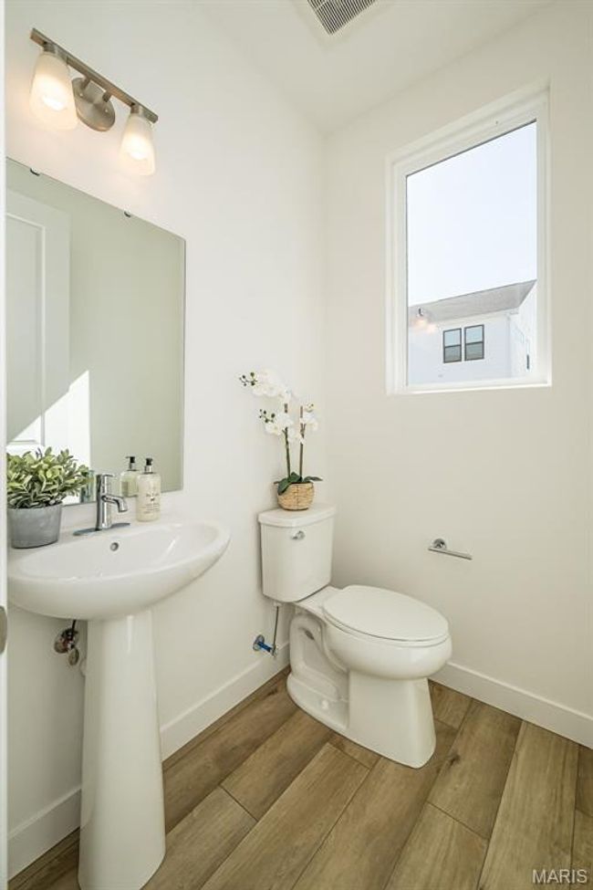 Half bath with toilet and wood finished floors | Image 18