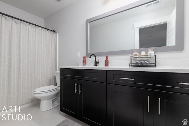Full bathroom with vanity, toilet, visible vents, and tile patterned flooring | Image 29