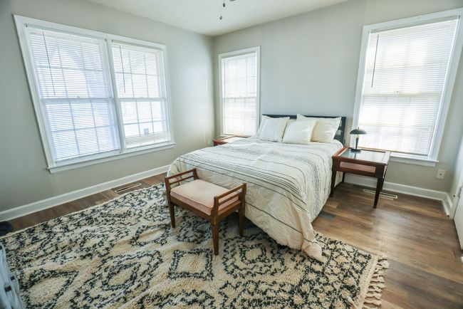 Bedroom featuring visible vents, baseboards, and wood finished floors | Image 20