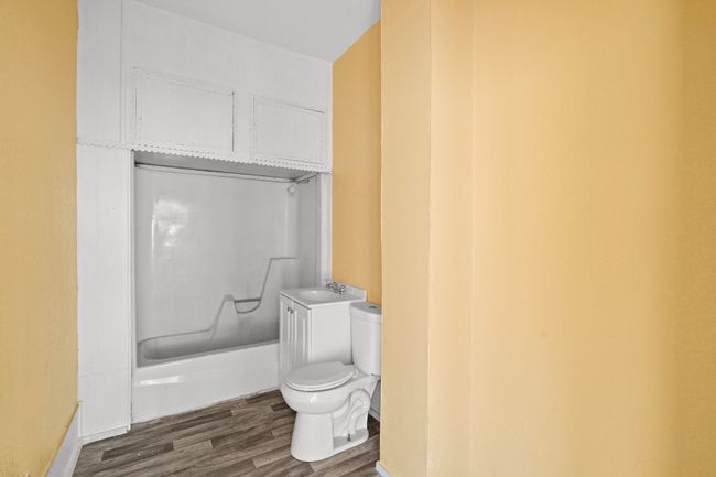 Bathroom featuring toilet, wood finished floors, and a sink | Image 10
