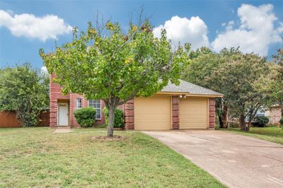 View of front of home with a garage and a front lawn | Image 2