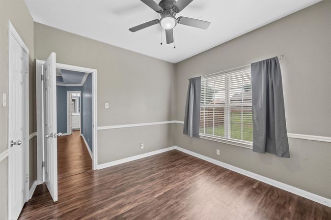 Spare room with dark wood finished floors and ceiling fan | Image 12