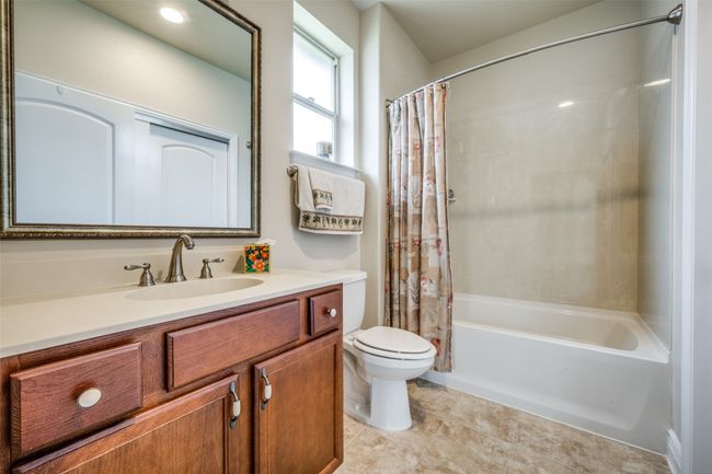 Bathroom featuring vanity, shower / tub combo with curtain, and tile patterned flooring | Image 6