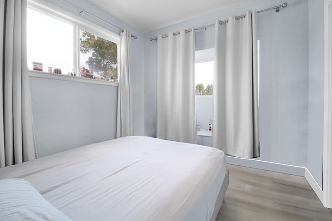 Bedroom with baseboards, multiple windows, and light wood-type flooring | Image 25