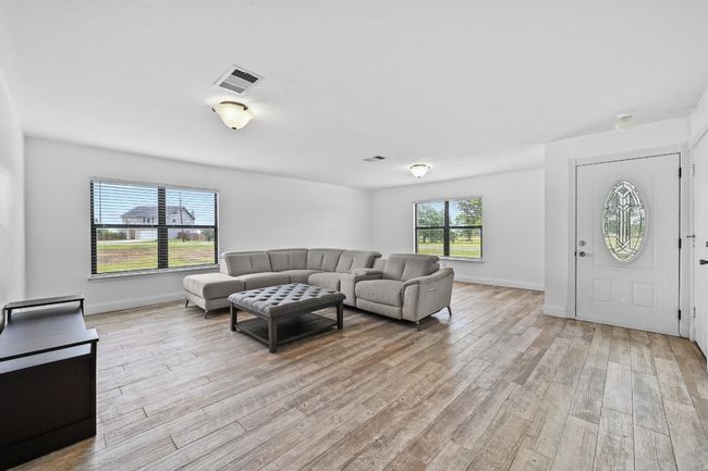 Living area featuring light wood finished floors and baseboards | Image 6