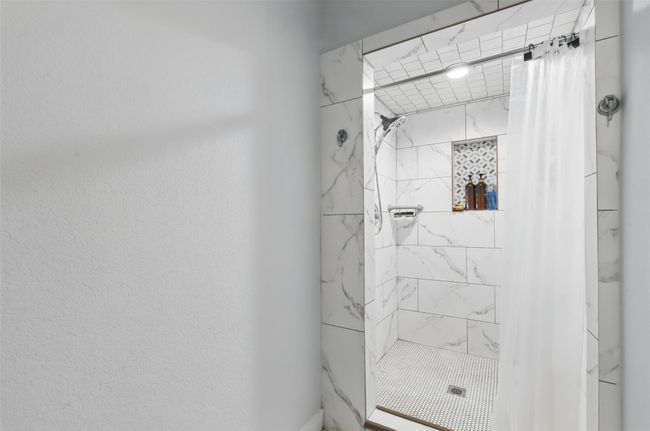 Full bathroom featuring a shower stall | Image 28