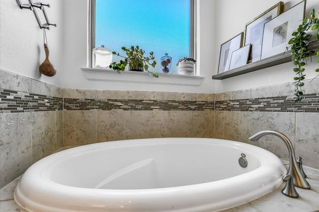 Bathroom featuring a bathtub | Image 20
