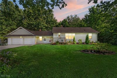 Ranch-style home with a lawn and a garage | Image 1