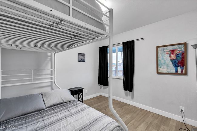 Bedroom featuring baseboards and wood finished floors | Image 25