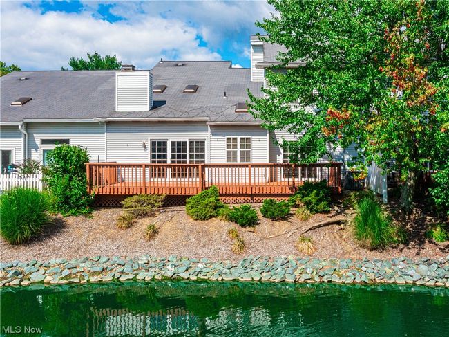Back of house with a deck with water view | Image 34