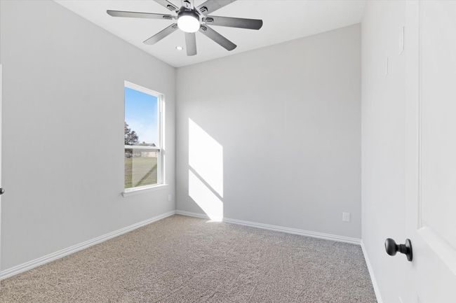 Spare room with carpet floors and a ceiling fan | Image 9