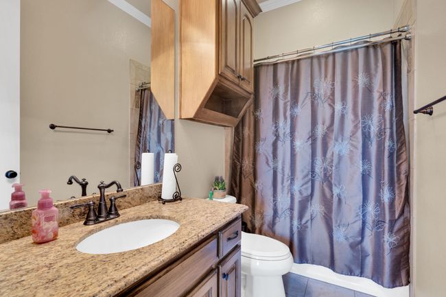 Full bath with vanity, ornamental molding, tile patterned floors, and shower / bath combination with curtain | Image 29